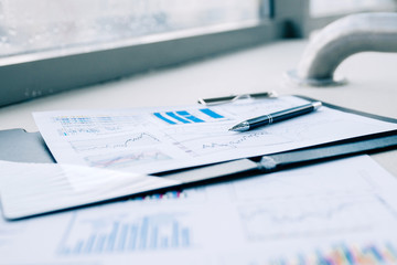 pen and financial documents on the desktop in the office