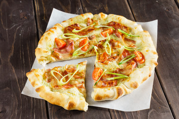 tasty pizza on the wooden background