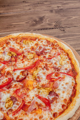 Pizza with Mozzarella cheese, salami, Tomatoes, pepper, Spices. Italian pizza