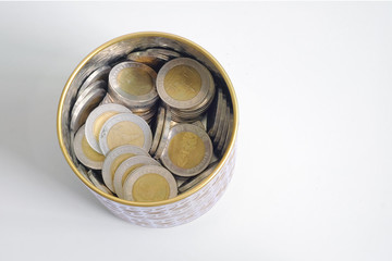 Thai money coin in bottle saving for future and investing. Top view isolated on white background.