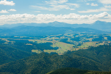 Naklejka premium Beautiful mountain landscape, with mountain peaks covered with forest and a cloudy sky. Ukraine mountains, Europe