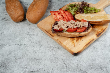 Sandwich Tuna with filling from lettuce, tomato with whole wheat bread.