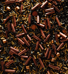 Different size bullet shells on the black ground. War concept. production of ammunition at the...