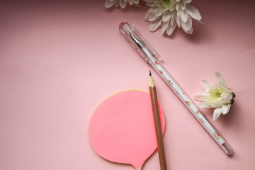 Pencil and stickers on pink background