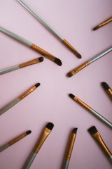 Makeup brushes on pink background