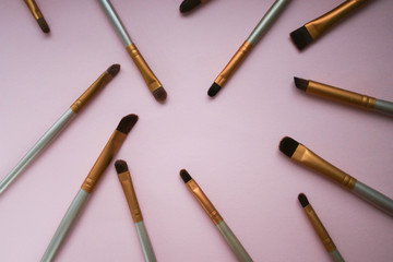 Makeup brushes on pink background