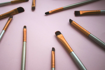 Makeup brushes on pink background