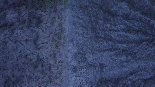 AERIAL: A hikers walks at the edge of Bromo volcano in Java island, Indonesia