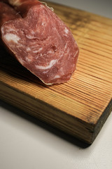 Piece of sausage on a wooden board