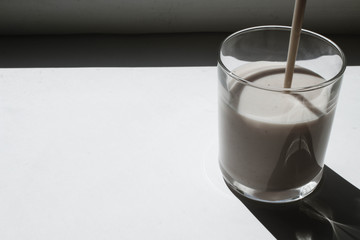 Glass of yogurt on the windowsill