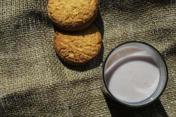 Cookies and a glass of yogurt on a piece of cloth