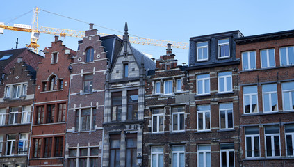 Fototapeta premium Old architecture houses in Belgium with crane in background