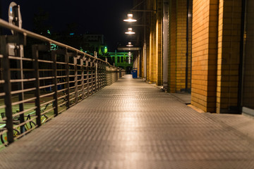 Illuminated walkway with railing, Walkway made of stall plates, Walkway at night