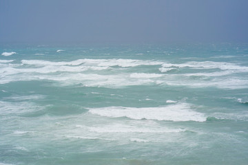 Naklejka na ściany i meble Early morning and strong wind. Sea pier large waves. 