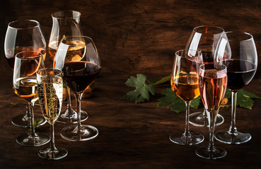 Wine tasting, still and sparkling wines. Red, white wine, rose and champagne шт assortment in wine glasses on vintage wooden table background