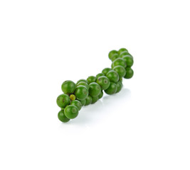 green peppercorns on white background