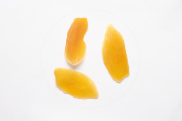 Candied mango slices isolated on white backgroud.