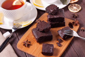 Pieces of chocolate cake on the kitchen board. Fresh homemade cakes. Chocolate biscuit. Brownie.