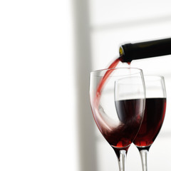 pouring red wine into glass