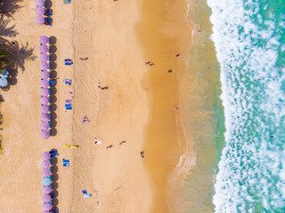 Fototapeta na wymiar Aerial view white sand sea beach with colorful umbrella