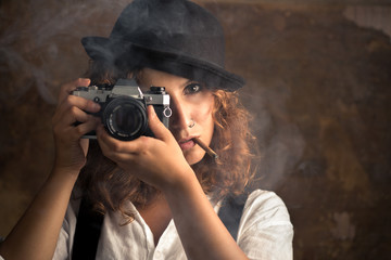 Woman Photographer with Bowler and Suspenders Smoking a Cigar
