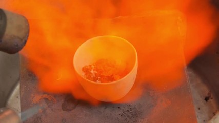 Melting metal in crucible two burners