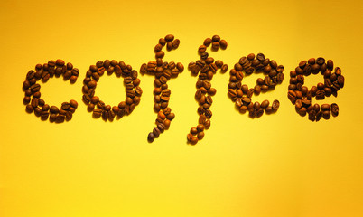 inscription coffee made from coffee beans on a yellow background. menu and advertising of cafe and goods