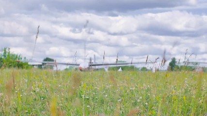 There is a glider on the field. The glider is out of focus