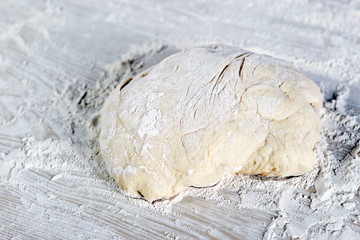 dough with flour on a white background, Dough ready for cooking