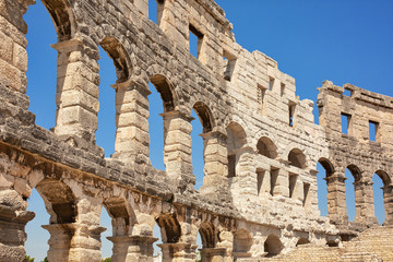 Naklejka premium Ancient wall of amfitheater in Pula, Croatia. Historic heritage tourism and travel background