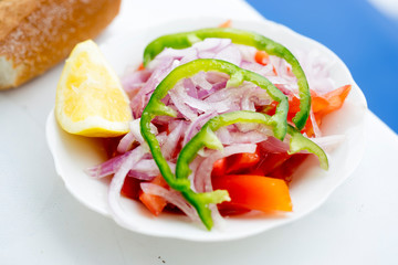Moroccan salad with green pepper, tomato, red onion and lemon 