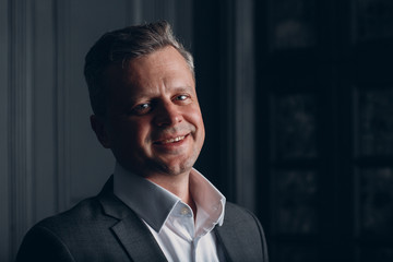 Portrait closeup of a businessman in strict gray suit. Business and success concept.