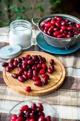 Fresh cornel berries on the kitchen table