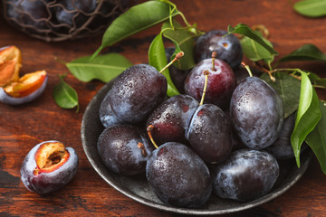 Plum fruits on rustic wooden background