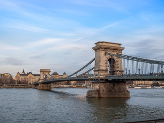 Fototapeta premium Budapest, Hungary - Mar 9th 2019: The Széchenyi Chain Bridge is a suspension bridge that spans the River Danube between Buda and Pest, the western and eastern sides of Budapest, the capital of Hungary