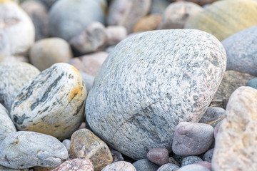 Detail of rounded and weathered granite stones found at the shore of Sweden