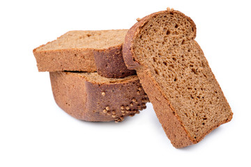 loaf of dark bread partly cut in slices, isolated on white