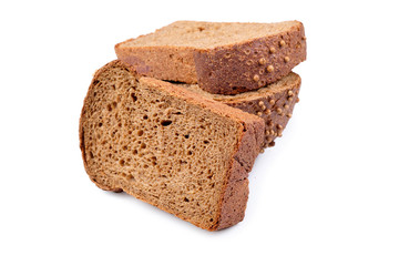loaf of dark bread partly cut in slices, isolated on white