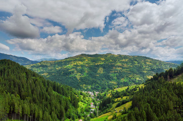 High mountain panorama drone fly above the mountains In summer. Aerial View Above in the Carpathian Mountains And Meadows.
