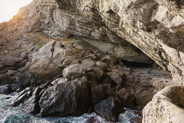 Tourists visiting the Grotto Golitsyn (Pop, Chaliapin grotto) — a large natural grotto, knocked out by sea waves in the mountain Koba-Kaya (Cave) near the village of Novy Svet in the Crimea