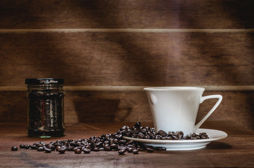 cup of coffee and beans on wooden table