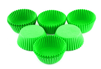 Green silicone form for cooking muffin and cupcake on white background. Molds for sweet and delicious muffins.