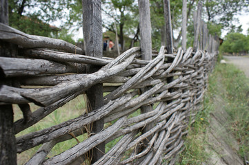 Fototapeta na wymiar wicker crooked rural fence, country fence in mountains