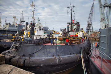 Tugboats and other marine support vessels in port.
