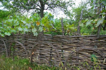 wicker crooked rural fence, country fence in mountains