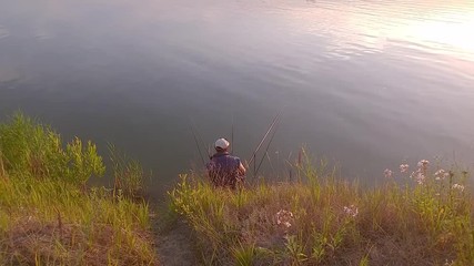 Fisherman angling on the river. Fisherman on the riverside and trying to catch a fish. Recreation and lifestyle