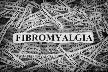 Torn pieces of paper with the word Fibromyalgia