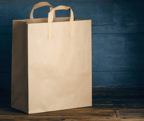 Paper package brown bag on wooden background