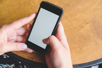 Woman hand using smartphone with white blank screen. Space for text