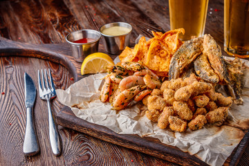 Set seafood: mussels, shrimps, small fried sea fish and crackers, food that is usually served with beer, horizontal orientation